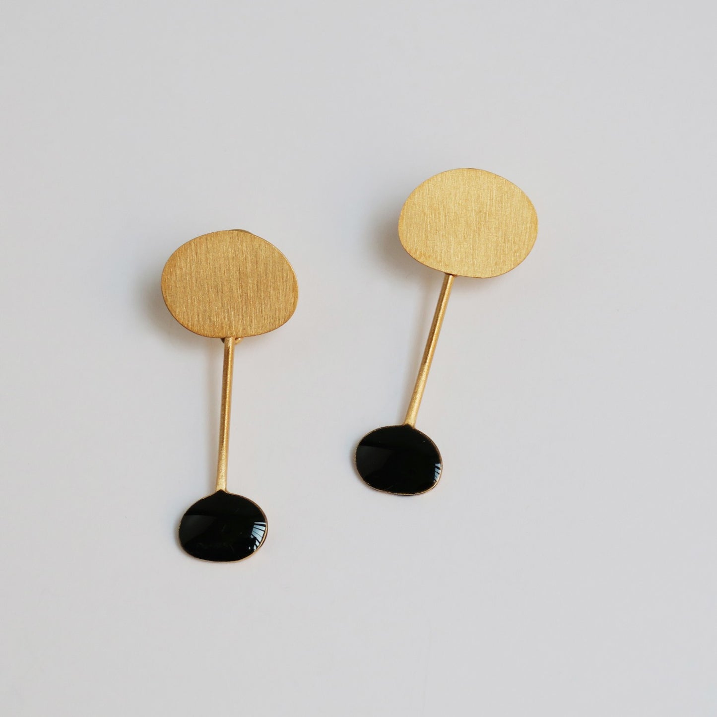 Golden Earrings and Black Miró Jewelry